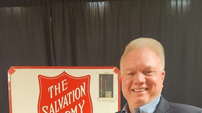 David in front of a Salvation Army sign Photo